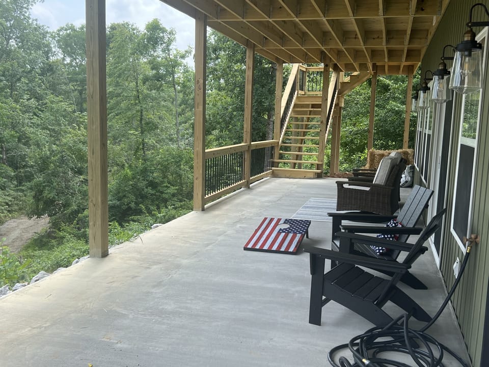 Walk out lower level with cornhole.  Grass area w/ fire pit coming fall.