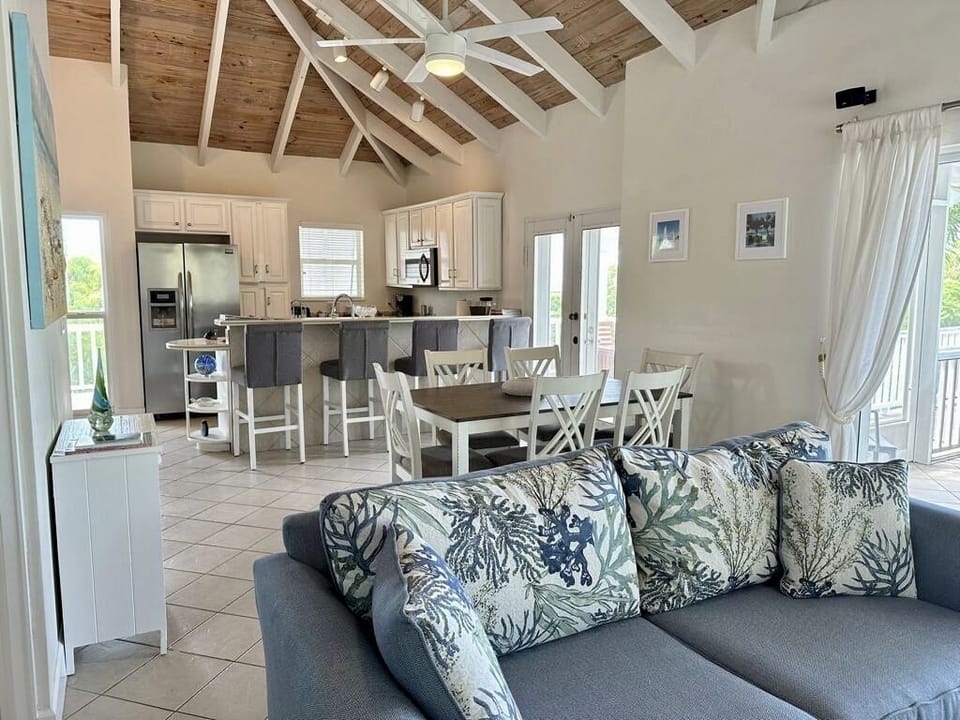 Kitchen has breakfast bar w/4 bar stools, dining table for 6 and 2 queen sofas.