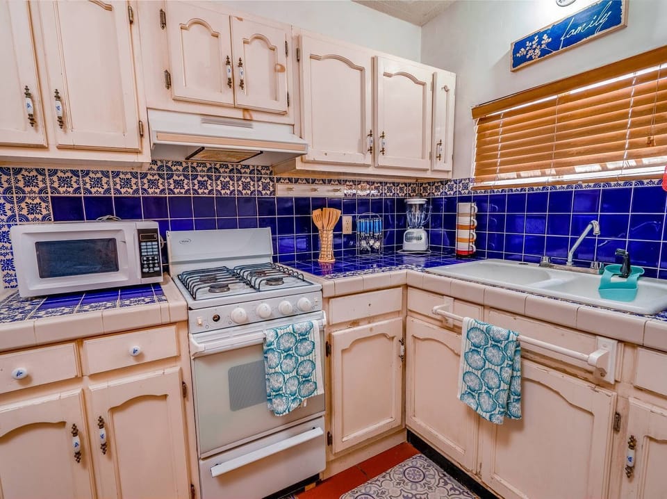 Save money on dining out. This kitchen at Casa Barquito vacation rental in San Felipe comes with stove, fridge, microwave, and counter space — everything you need to cook for your group.