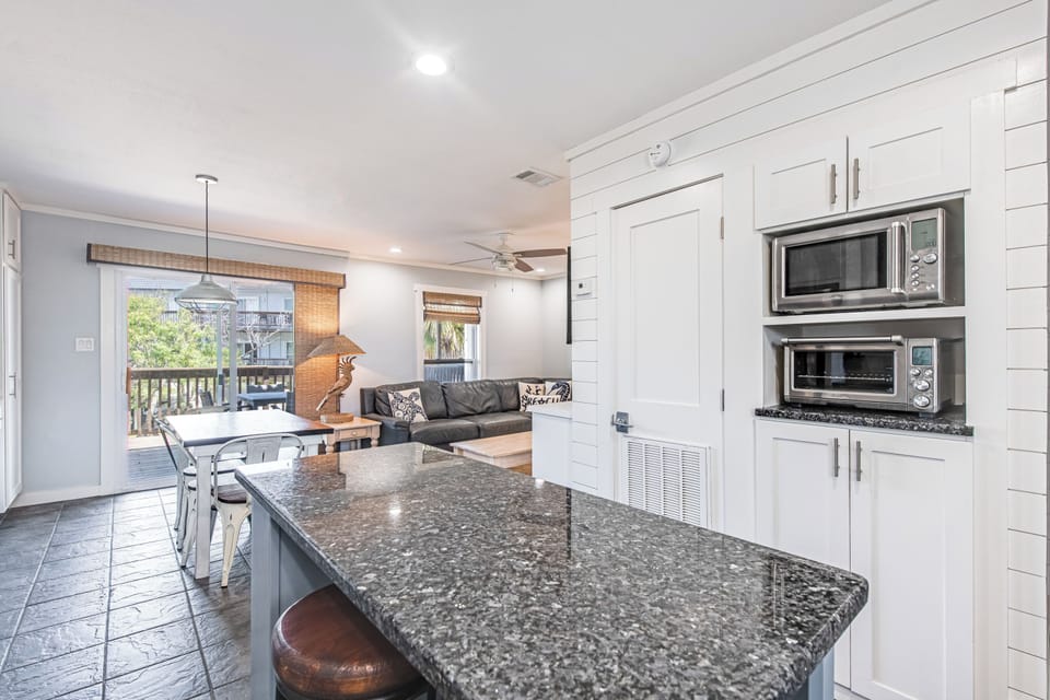 Cook in your gourmet kitchen while family relaxes nearby. Granite counters and modern appliances make meal prep effortless.