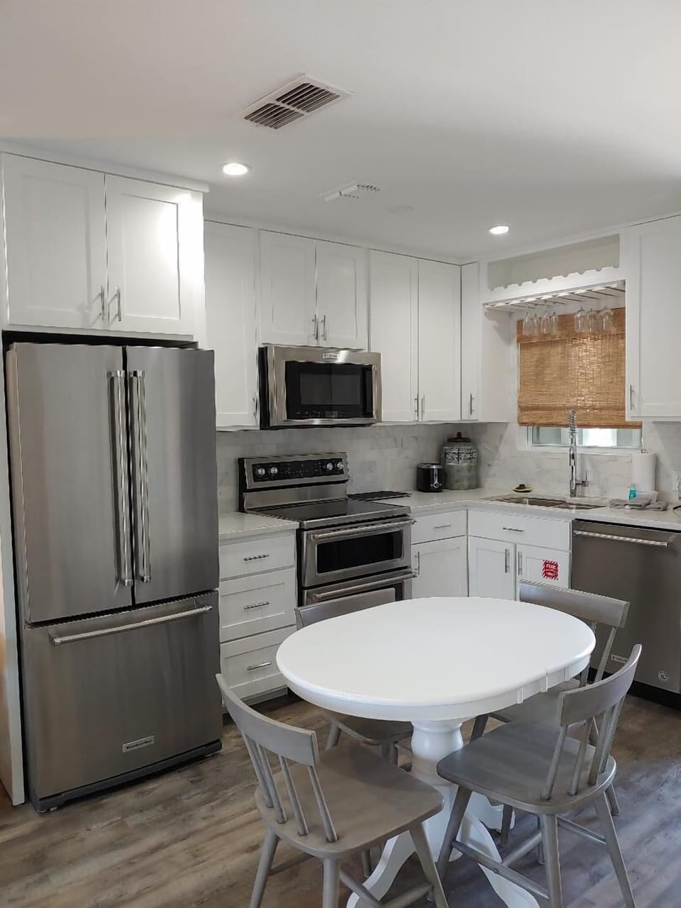 Your fully equipped kitchen features stainless steel appliances and a cozy dining nook perfect for morning coffee or intimate meals together.