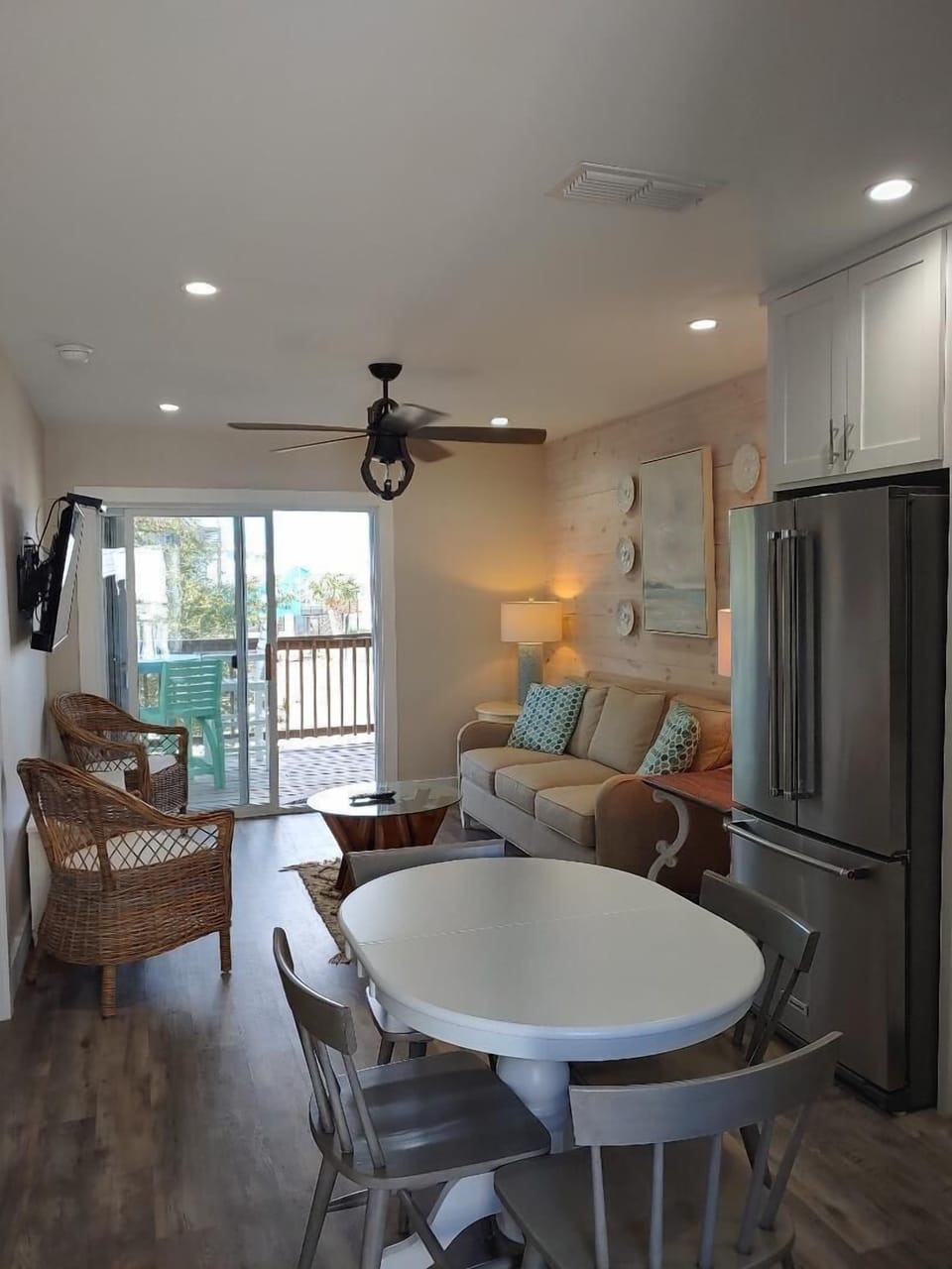 Your open-concept retreat seamlessly blends kitchen, dining, and living spaces with coastal charm and a private balcony for morning coffee.