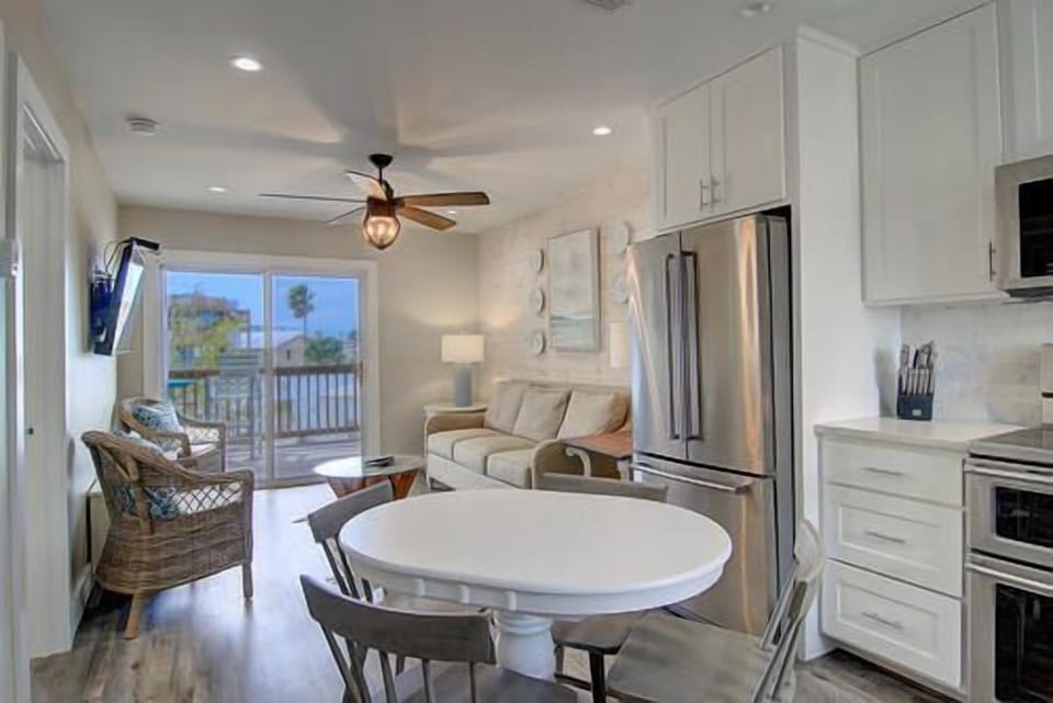 Your bright kitchen flows into a cozy living area where you can cook, dine, and unwind while enjoying views beyond.