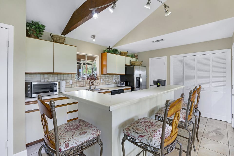 Bar seating surrounding the kitchen