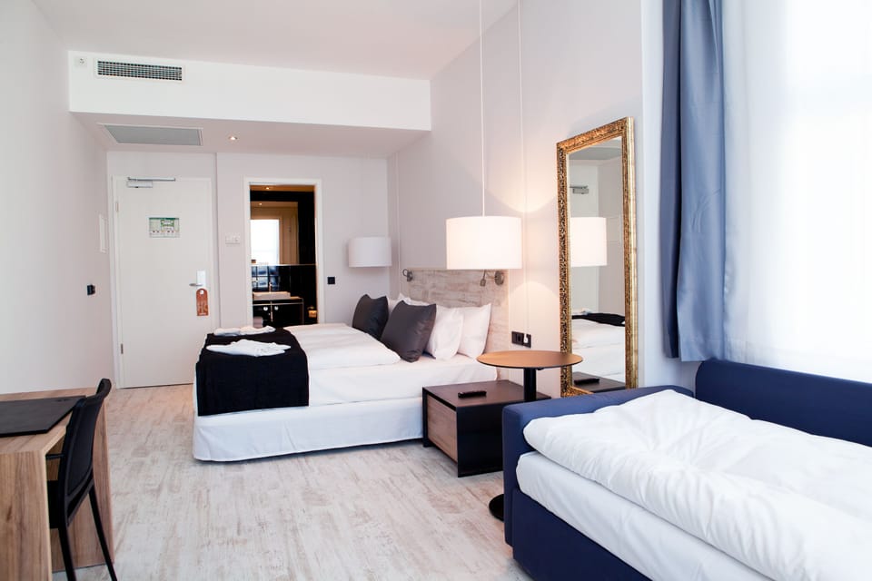 Superior Triple Room | Living area | Flat-screen TV