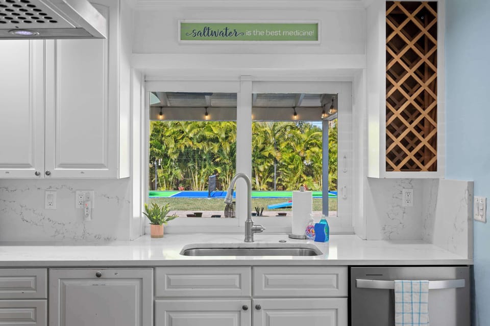 Kitchen: Bright views of the heated pool and lush backyard invite culinary creativity!

