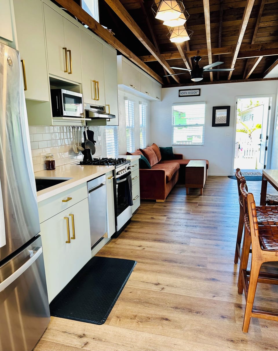 Open concept kitchen, dining room, and living room. Vaulted ceilings.