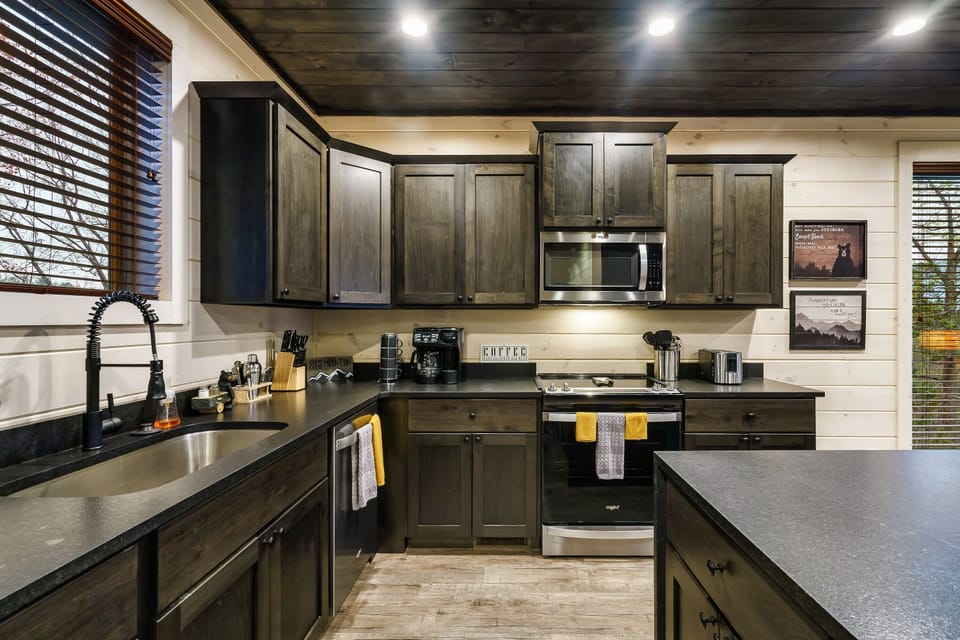 The open kitchen is stocked with pots and pans + one of 3 coffee stations.