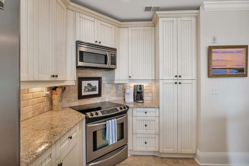 Kitchen with stainless stove and microwave