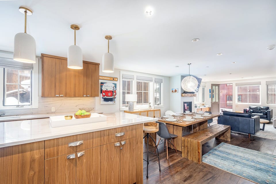 The open living area opens to a private balcony which features stunning mountain views, outdoor seating and a gas grill.
