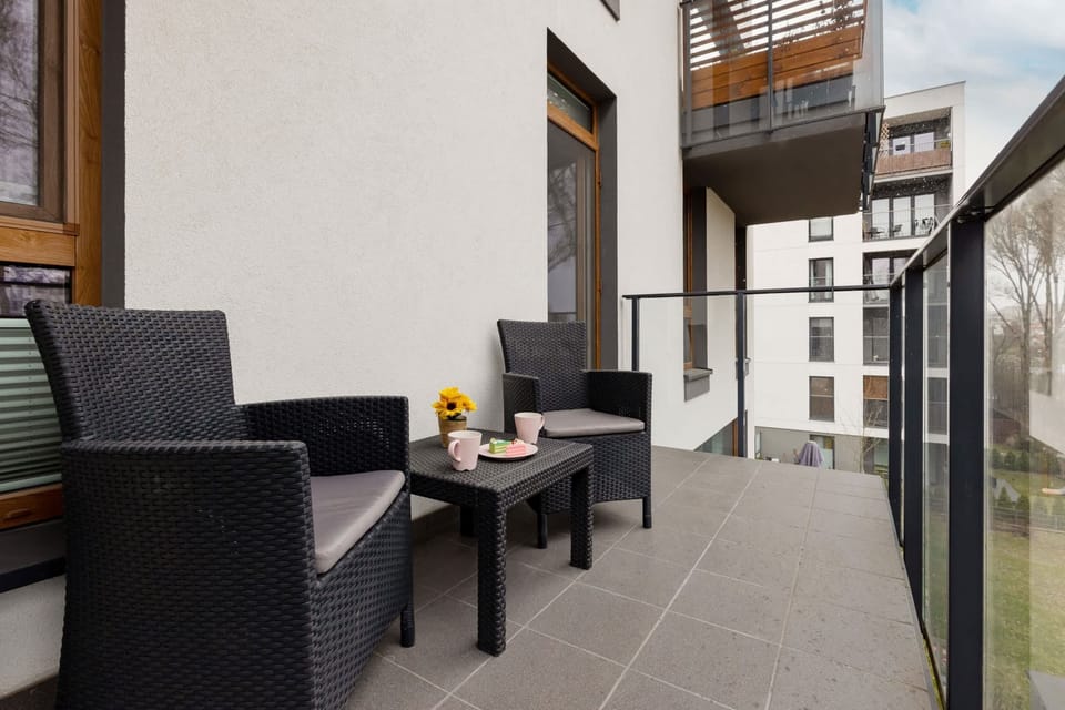 A small outdoor patio with comfortable seating, perfect for relaxing in fresh air.
