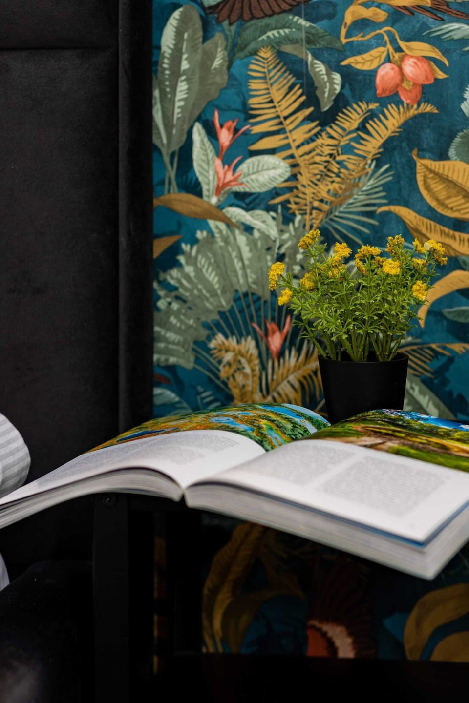 A decorative detail of a book placed against a vibrant floral background, adding charm.
