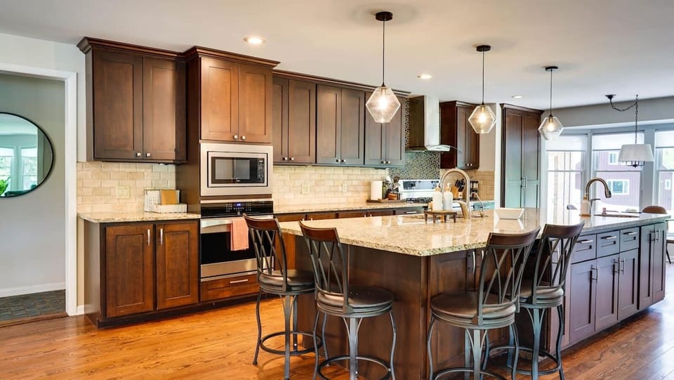 Gourmet kitchen with  12-ft island, bar seating, granite countertops, double ovens, prep sink. Truly a space to gather.  Also provided: Instant Pot, Crock Pot, Griddle, Blender. 