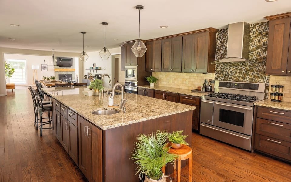 Kitchen opens to breakfast table seating on one side, and bar & dining seating on the other. The easy flow around the huge 12ft island entices everyone to be a part of meal prep and clean up!