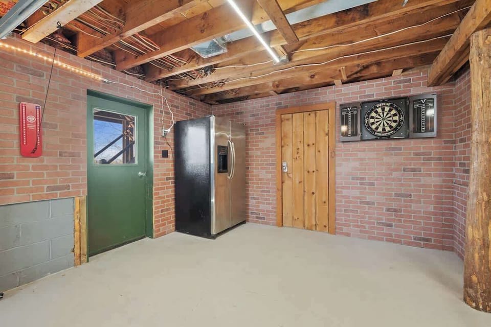 Enjoy a game of darts or ring toss! Extra stainless steel refrigerator with ice machine for your convenience!