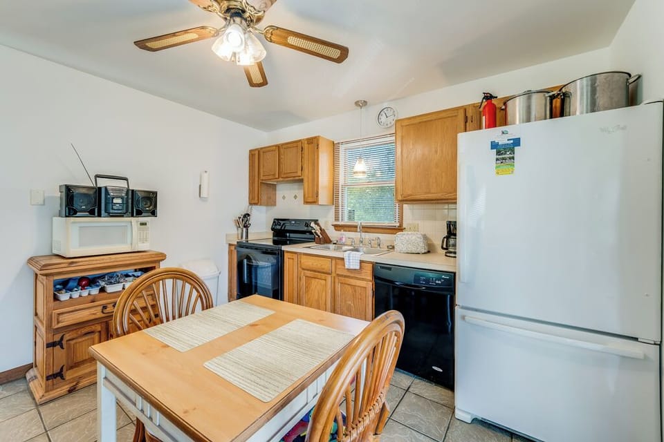 Enjoy all the comforts of Home in the well-stocked Kitchen that leads to the Screened Porch.