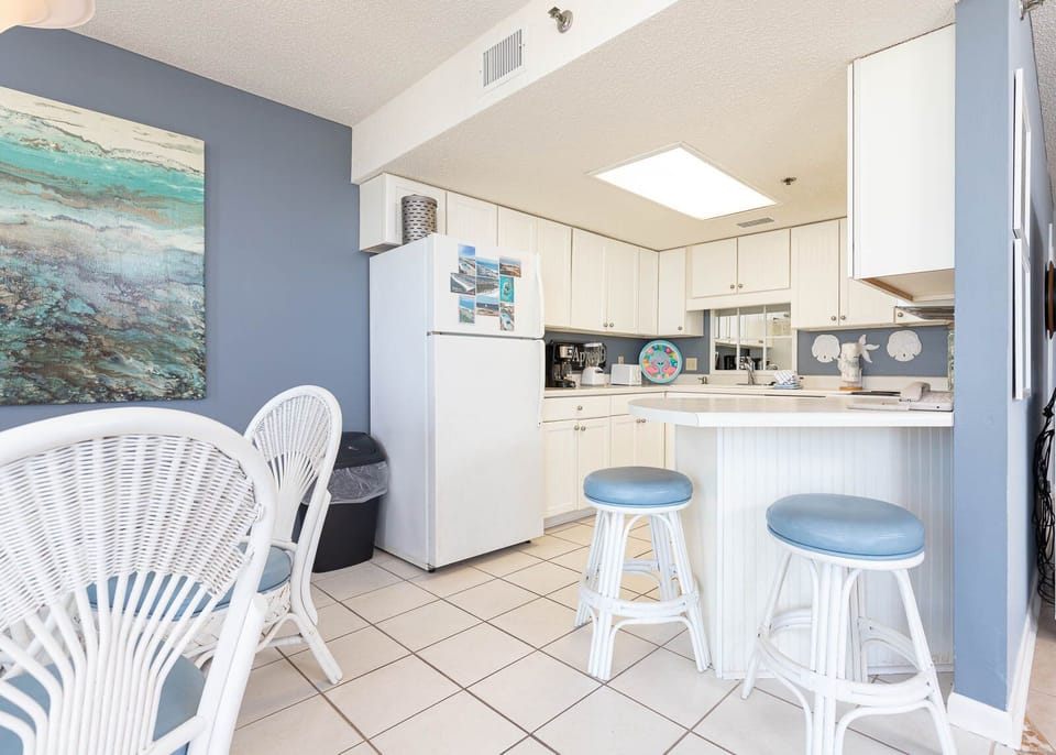 Gather around the breakfast bar with friends, enjoying the cheerful decor and easy access to the kitchen