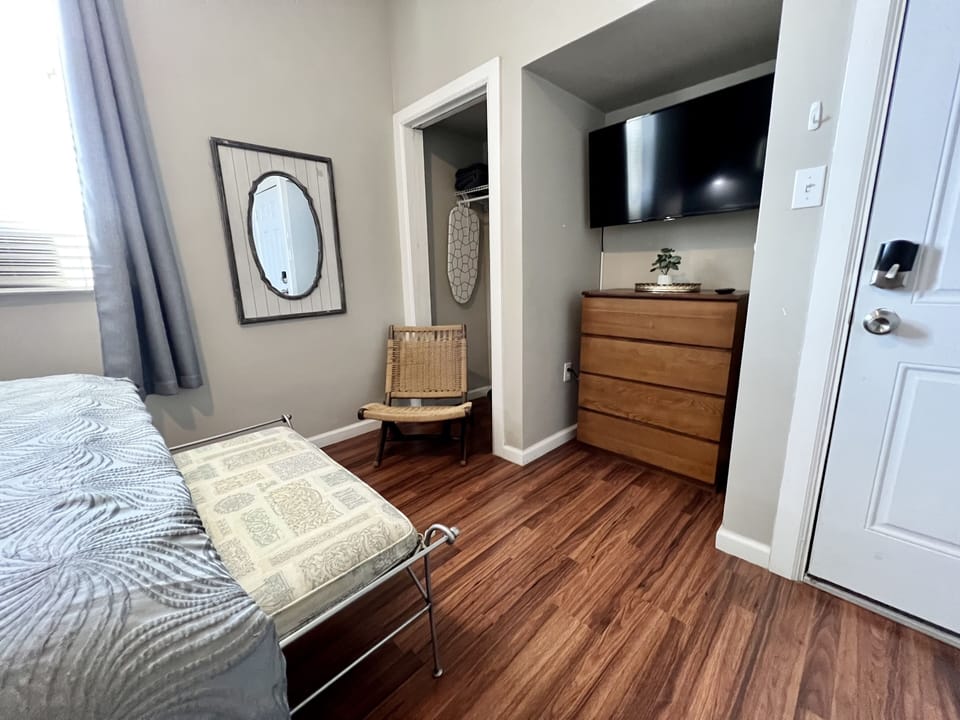 Extra closet space and dresser. Bench at end of bed and small lounge chair.