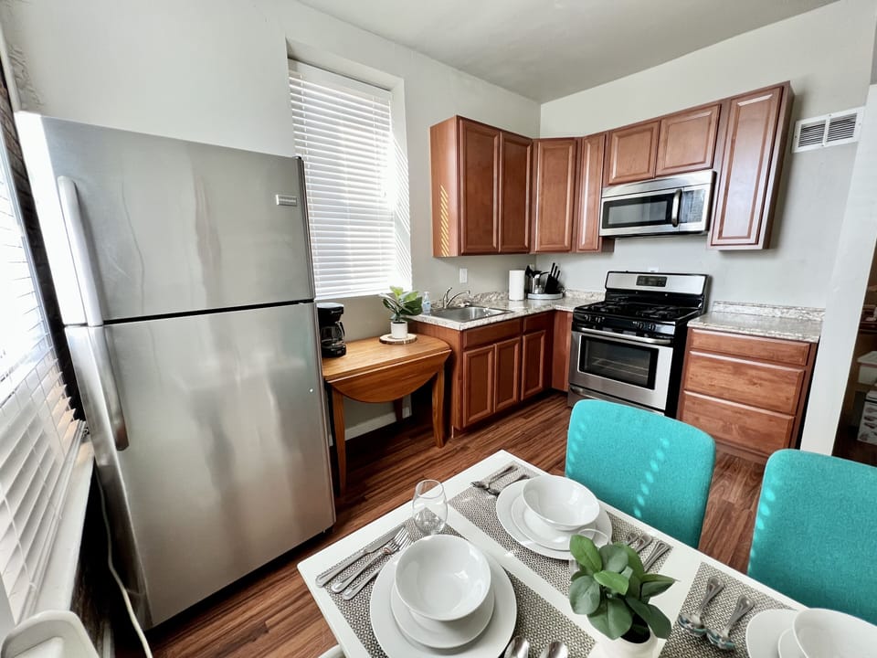 Fully stocked kitchen with stainless steel appliances and coffee maker