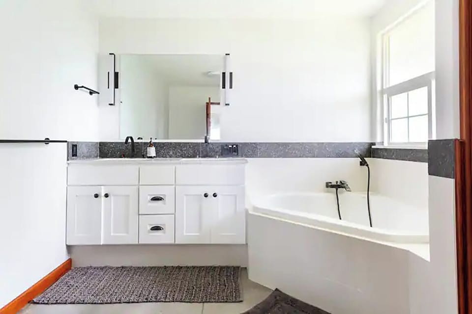 Soaking tub with separate shower and dual vanity sinks