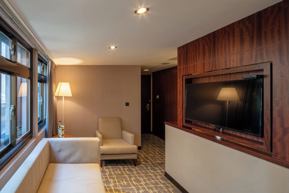 Deluxe Quadruple Room | Living area | 43-inch TV with digital channels
