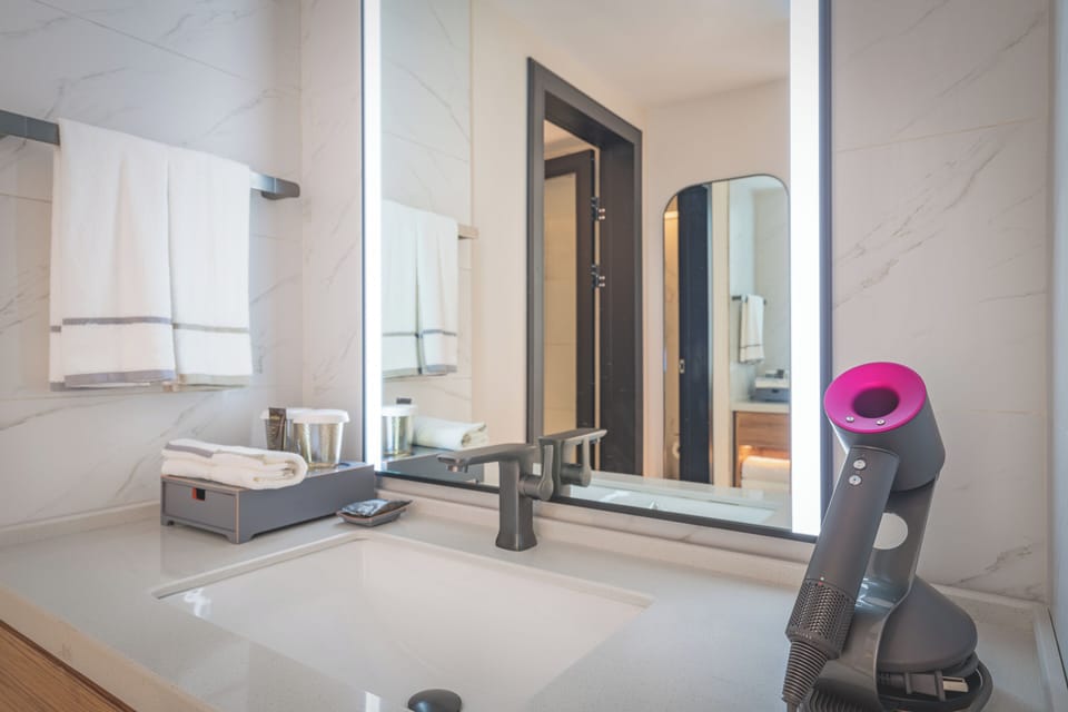 Executive Double Room | Living area | 65-inch LCD TV with cable channels, TV, smart speakers