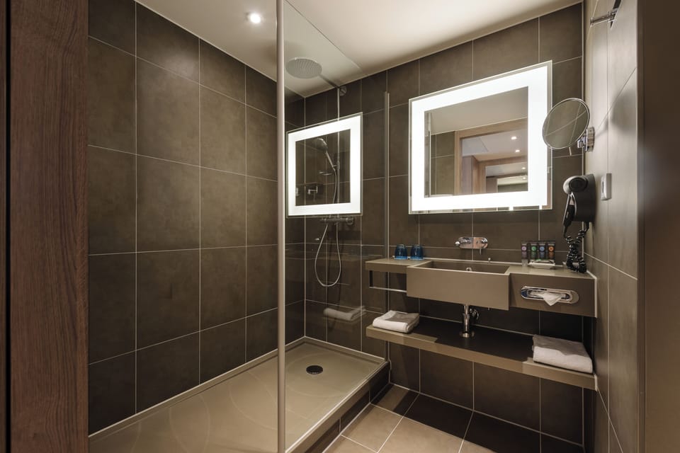 Eco-friendly toiletries, hair dryer, slippers, towels