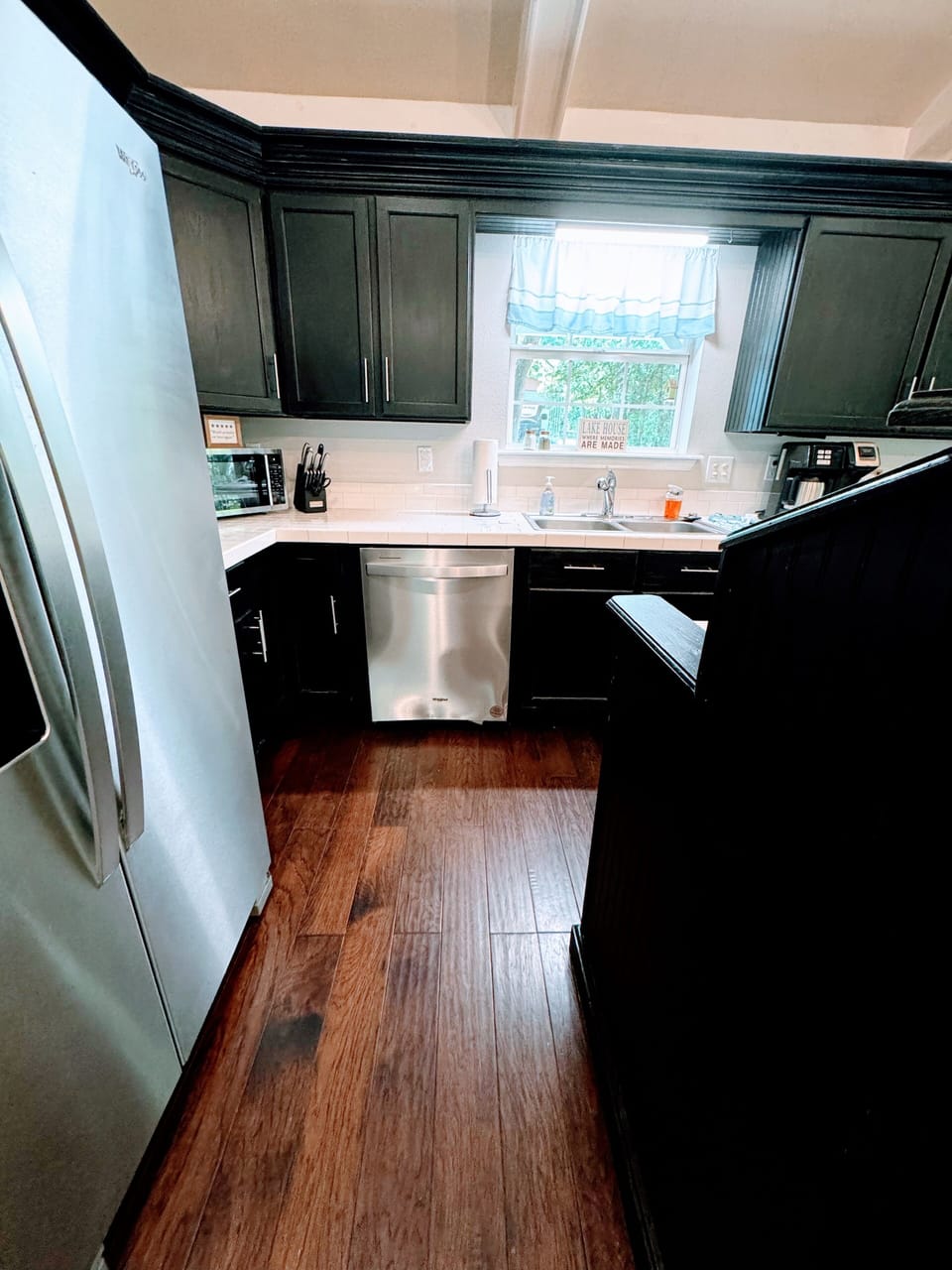 On the left is the fridge then the dishwasher is by the sink.
