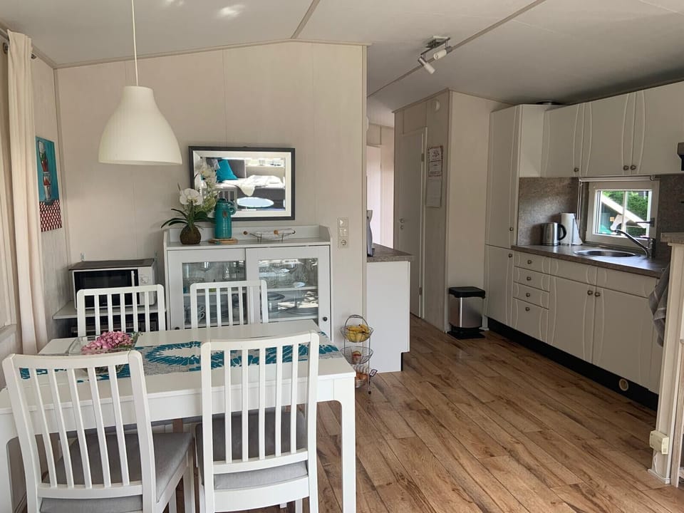 Dining table and kitchen at Campground the Zandput 470