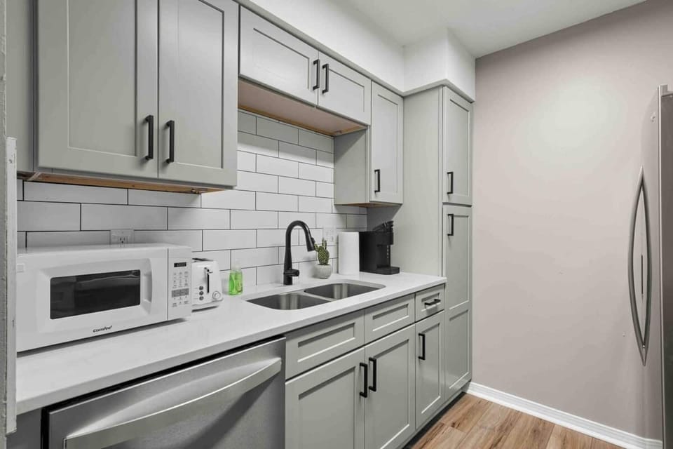 Kitchen view to dining room. All new cabinets and quartz counters. Stainless steel appliances, microwave, toaster, keurig coffee maker. Deep sink. Faucet with spray nozzle. Dishwasher