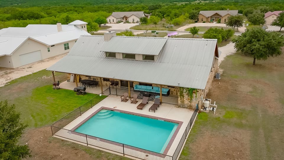 Aerial view of house + swimming pool