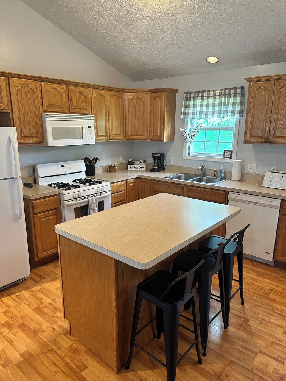 Fully stocked kitchen with island and counter seating. 