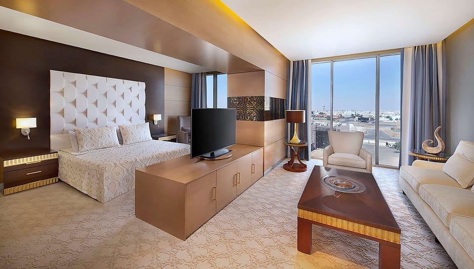 Deluxe Suite, 1 Bedroom | Living area | 42-inch LED TV with cable channels, TV
