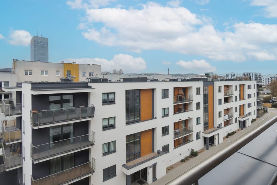 A spacious balcony offering a sweeping view of the city. Ideal for outdoor lounging or dining.