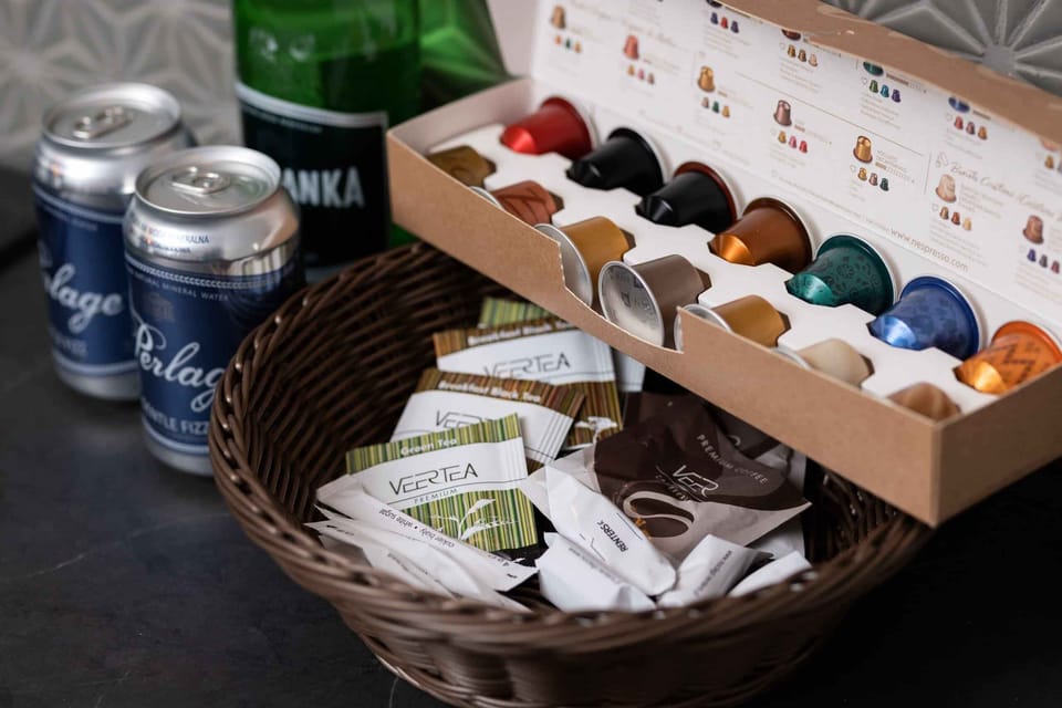 A basket filled with a variety of coffee pods and tea bags, thoughtfully prepared for guests. An inviting touch for a cozy morning.

