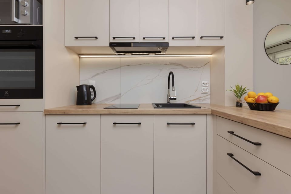 Kitchenette with oven and refrigerator. 