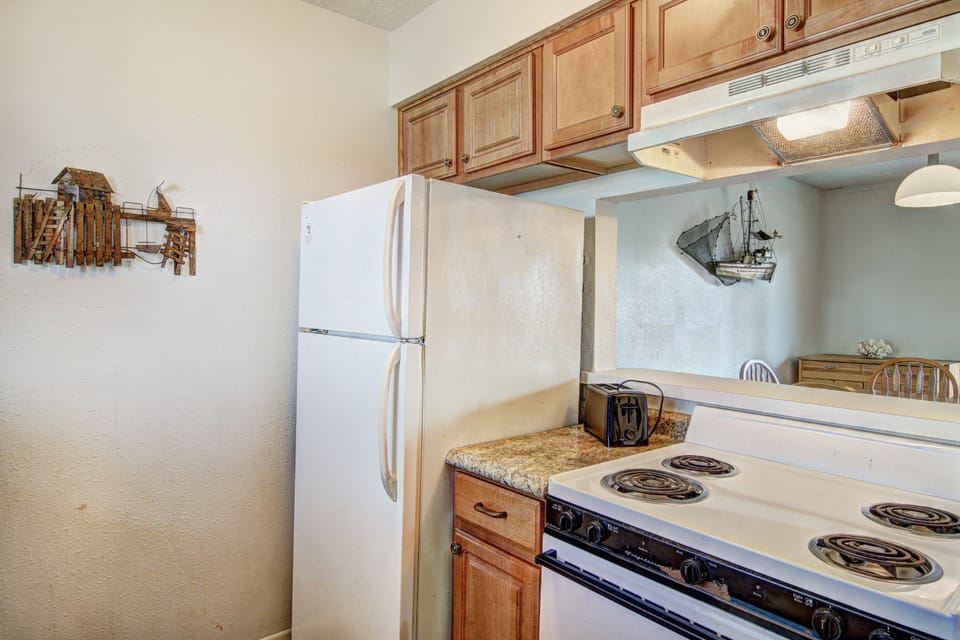 Your fully equipped kitchen features warm wood cabinets, granite countertops, and everything you need to prepare delicious meals during your stay.
