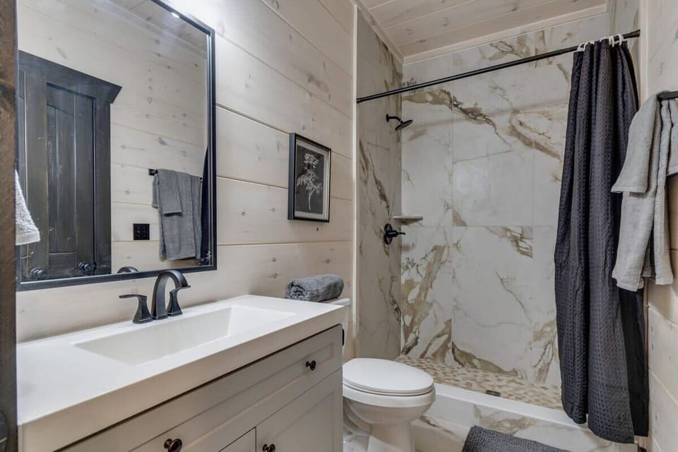Large tiled showers with shampoo, conditioners, and body wash supplied.