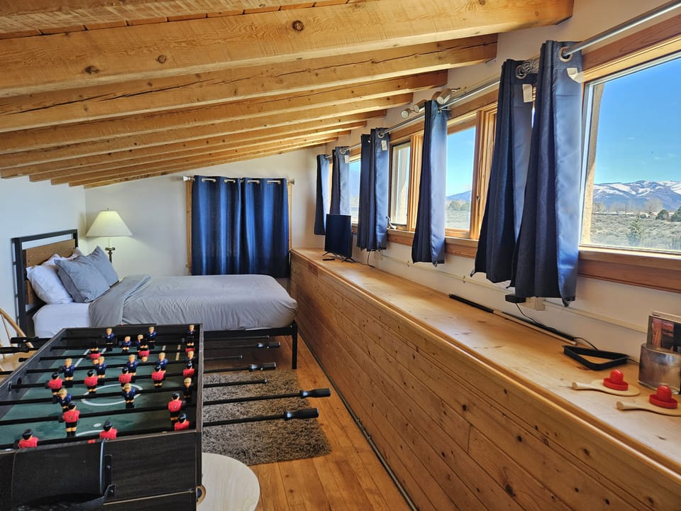 Queen loft bedroom with foosball table