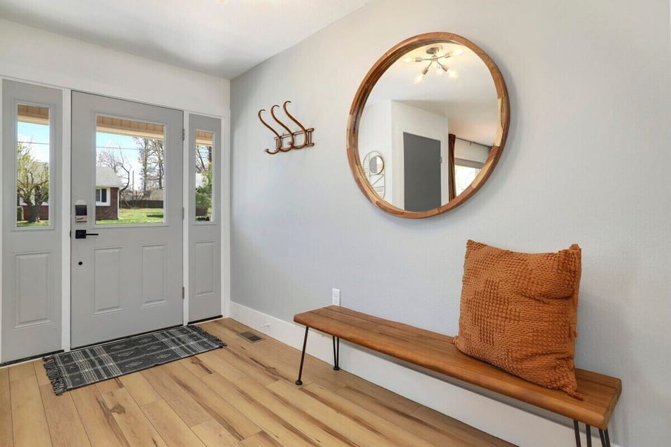 Near our front door, you'll find a small bench and a few hooks for storage.