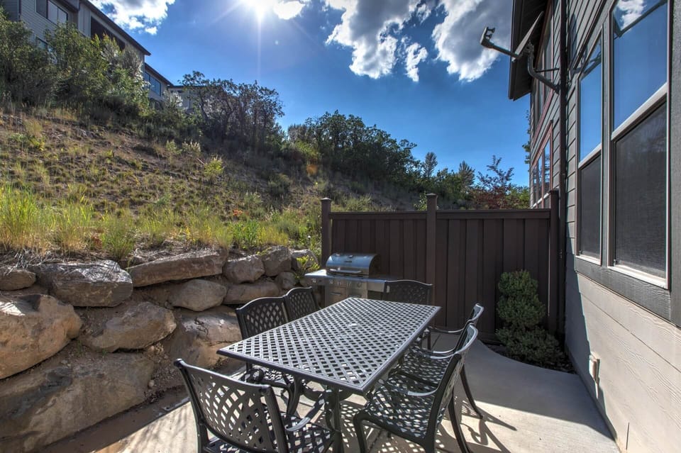 Your private patio invites sunlit mornings and al fresco dining, framed by natural hillside beauty. Fire up the grill, soak in blue skies, and unwind in your own outdoor retreat.