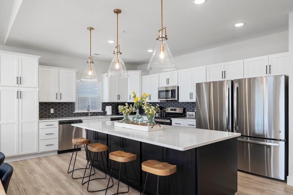 Fully stocked kitchen with two refrigerators — perfect for cooking meals for large groups.