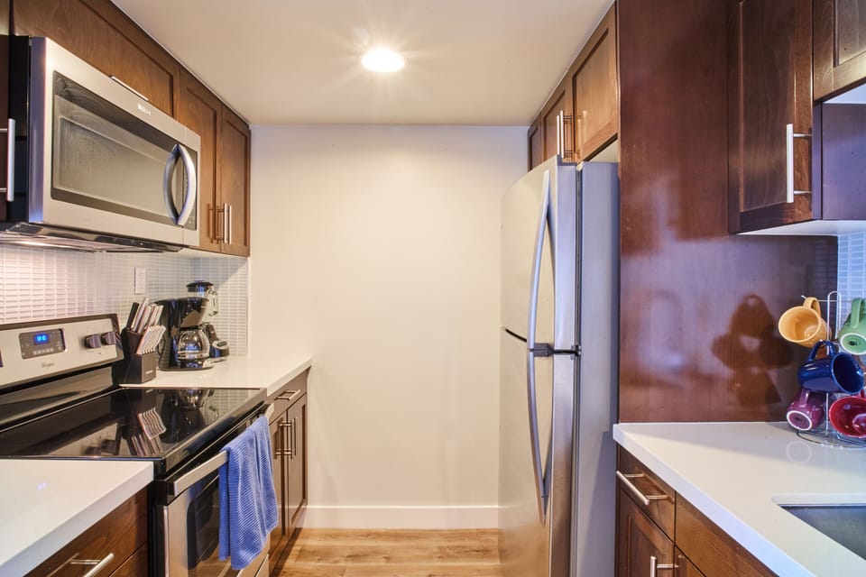 Modern kitchen with full-size, stainless steel appliances ready for your chef.