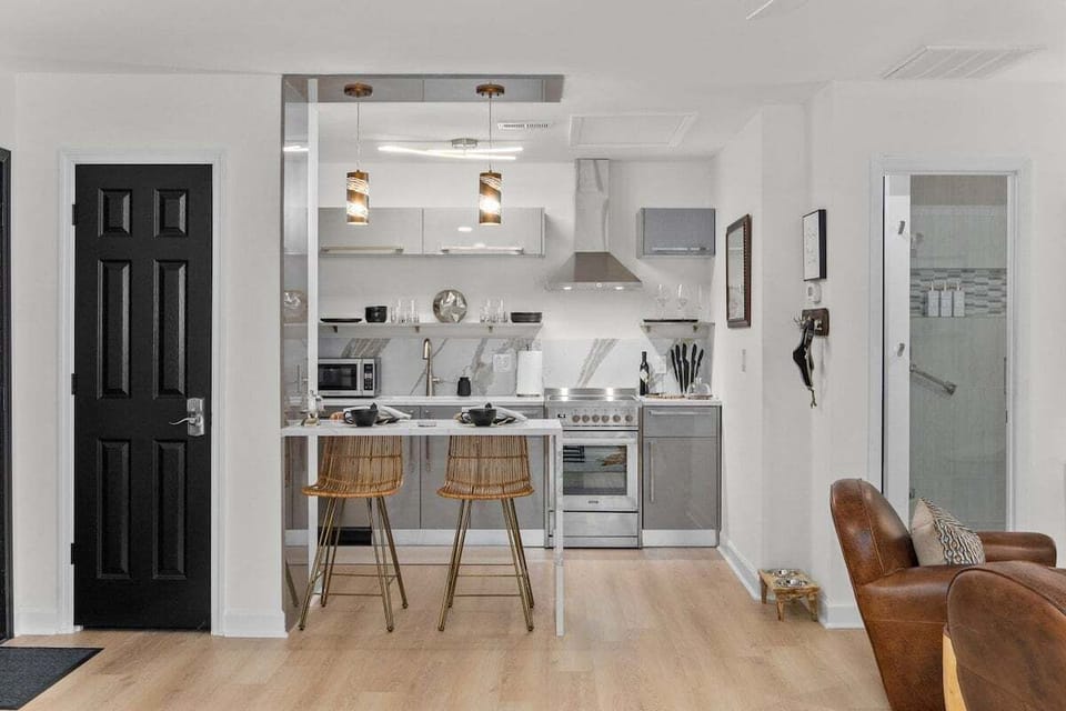 Modern and fully equipped kitchen with a spacious island. Enjoy the convenience and comfort as you cook up delicious meals. Gather around the stylish bar chairs for a casual dining experience and create lasting memories.