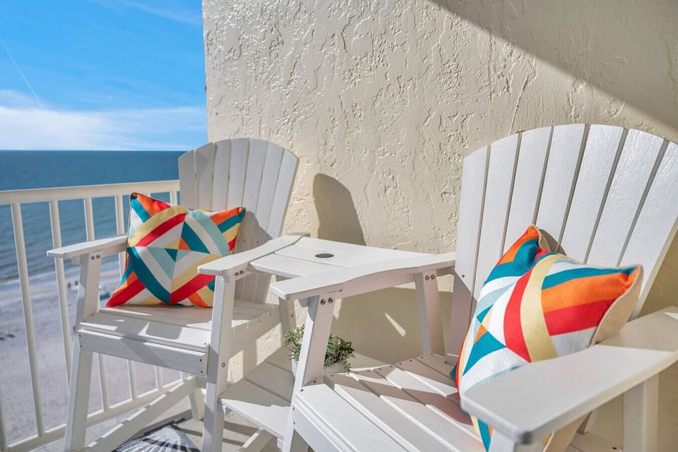 Balcony seating w/ Adirondack chairs, perfect for morning coffee by the water.