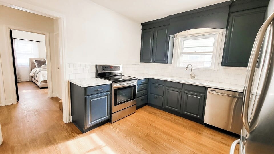 Kitchen with oven, sink, dishwasher, microwave and fridge.