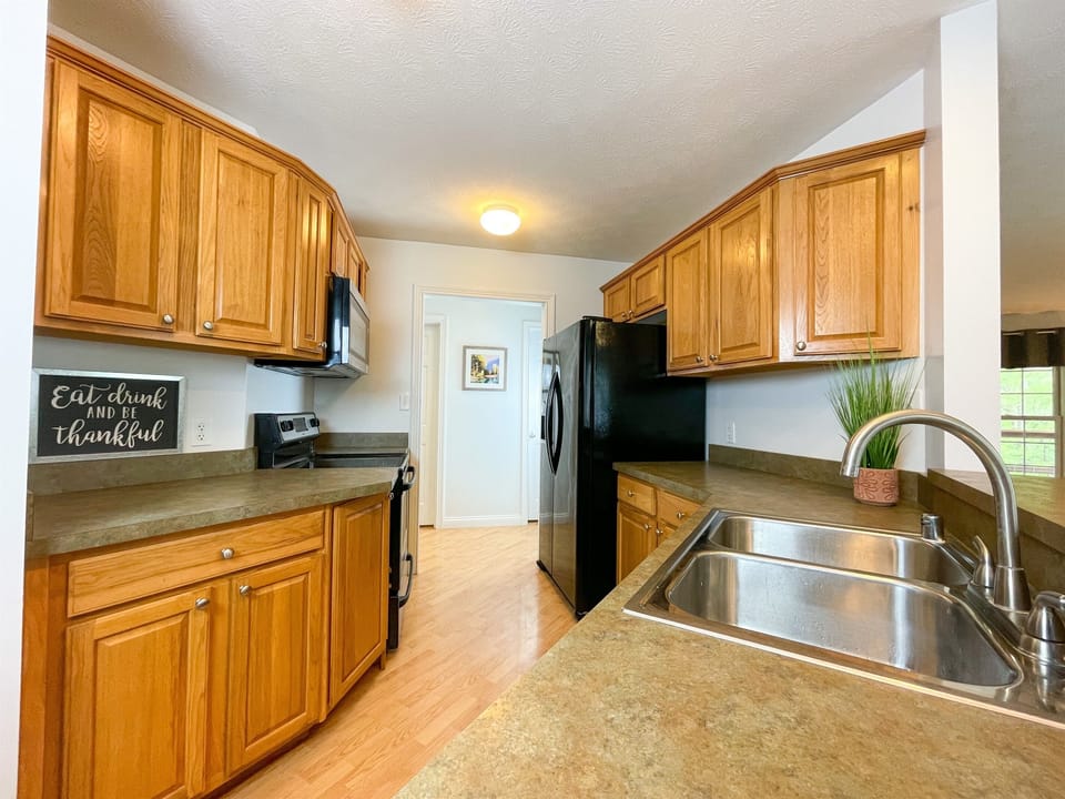 Adjacent to the living room, you'll find a well-equipped kitchen with everything you need to prepare and enjoy meals during your stay