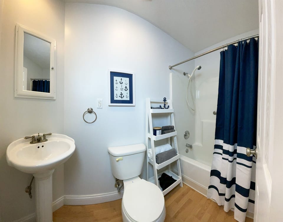 The guest bathroom is right off the main hall and features a tub/shower combination