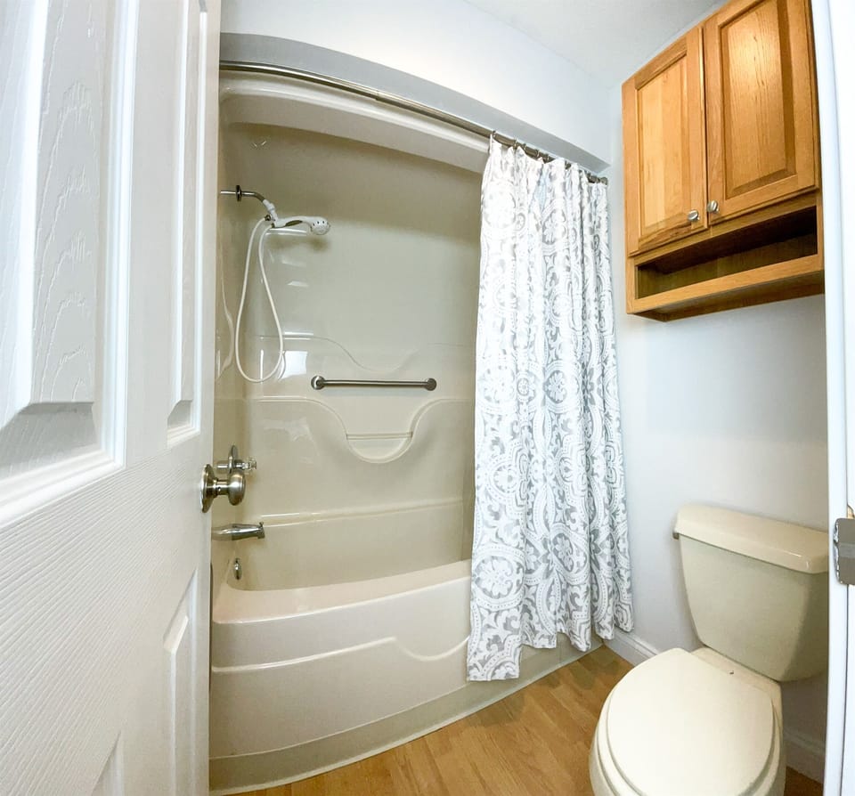 The ensuite bathroom is equipped with fresh towels, toiletries, and a hairdryer for your convenience.