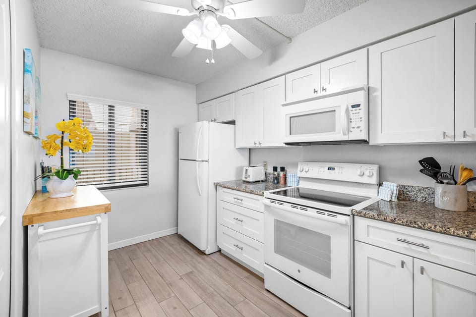 Fully equipped kitchen includes stove, microwave oven, blender, coffee maker, toaster, dinnerware and cookingware